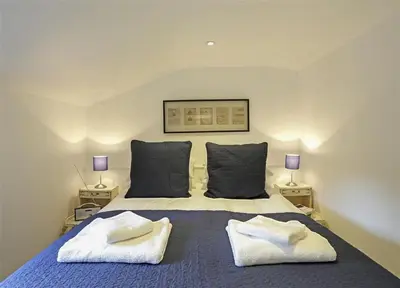 a bedroom with a bed with two towels on it at 2 Bed in Aldeburgh oc-tsc in Aldeburgh