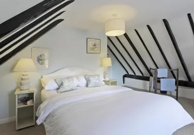 a bedroom with a large white bed with black beams at 3 Bed in Leiston oc-wil in Theberton