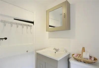 a white bathroom with a sink and a mirror at 3 Bed in Leiston oc-wil in Theberton