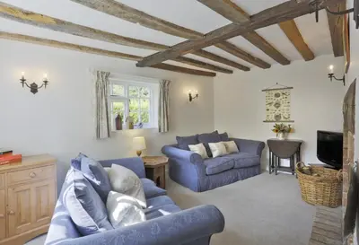 a living room with two blue couches and a tv at 3 Bed in Leiston oc-wil in Theberton