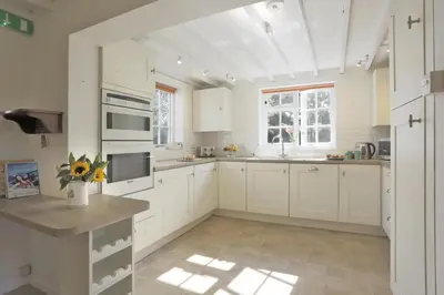 a kitchen with white cabinets and a large window at 3 Bed in Leiston oc-wil in Theberton
