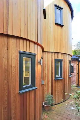 a wooden building with two windows on the side of it at 2 Bed in Woodbridge oc-zep in Woodbridge