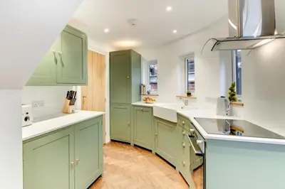 a kitchen with green cabinets and white counter tops at 2 Bed in Woodbridge oc-zep in Woodbridge