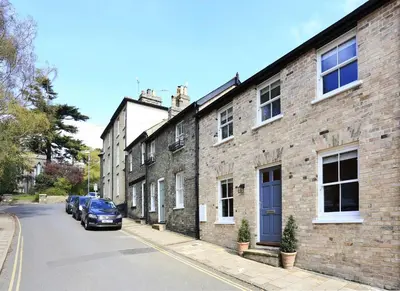 a brick building with a blue door on a street at 2 Bed in Woodbridge oc-zep in Woodbridge