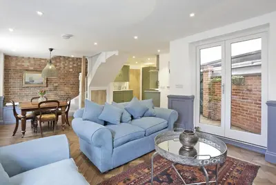 a living room with a blue couch and a table at 2 Bed in Woodbridge oc-zep in Woodbridge