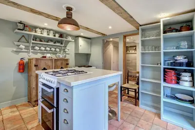 a kitchen with a white stove top oven in a room at 3 Bed in Nr Aldeburgh oc-sfwws in Snape