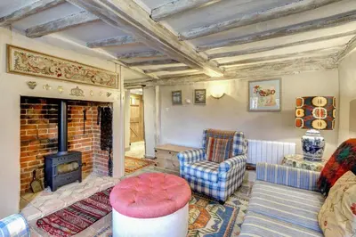 a living room with a couch and a fireplace at 3 Bed in Nr Aldeburgh oc-sfwws in Snape
