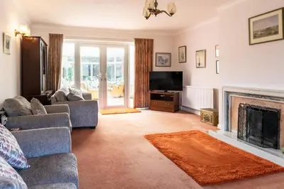 a living room with a couch and a fireplace at 4 Bed in Halesworth oc-willho in Halesworth