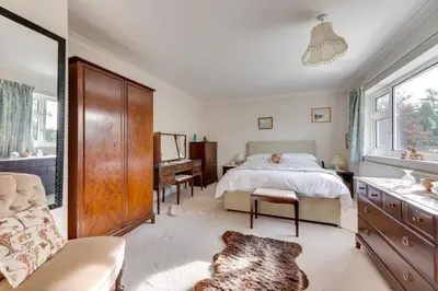 a bedroom with a bed and a desk and a chair at 4 Bed in Halesworth oc-willho in Halesworth