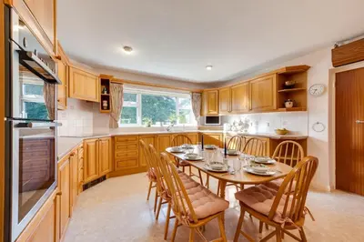 a kitchen with a table and chairs in a kitchen at 4 Bed in Halesworth oc-willho in Halesworth