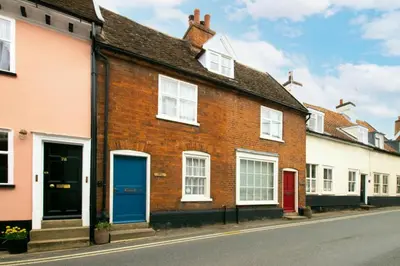 a row of houses with blue doors on a street at 2 Bed in Woodbridge oc-csn2 in Woodbridge
