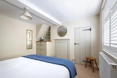 a white bedroom with a white bed and a window at 2 Bed in Woodbridge oc-csn2 in Woodbridge