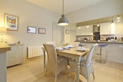 a kitchen and dining room with a table and chairs at 2 Bed in Orford oc-sfwco in Orford