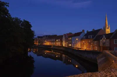 a river in a city at night with buildings at 1 Bed in St. James South Elmham Halesworth oc-t27361 in Saint James