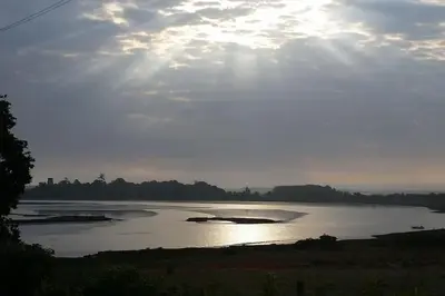 a large body of water with the sun in the sky at River Cottage - Stunning estuary views in Aldeburgh