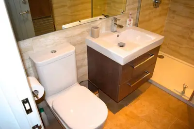 a bathroom with a white toilet and a sink at River Cottage - Stunning estuary views in Aldeburgh