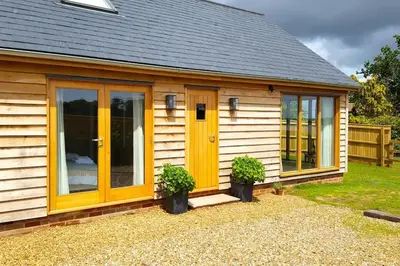 a small house with yellow doors and windows at River Cottage - Stunning estuary views in Aldeburgh