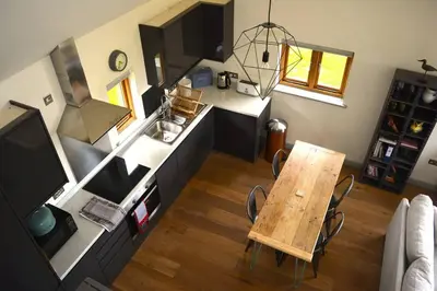 an overhead view of a kitchen with a wooden table at River Cottage - Stunning estuary views in Aldeburgh