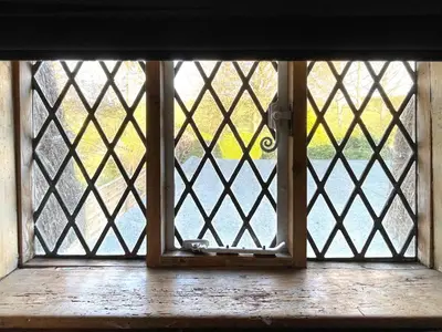 an open glass door with a view of a yard at Buttercup Cottage, Hartest in Hartest