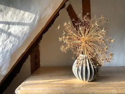 a vase sitting on a wooden shelf with a plant at Buttercup Cottage, Hartest in Hartest