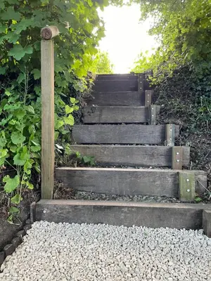 a set of concrete stairs with a wooden pole at Buttercup Cottage, Hartest in Hartest