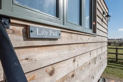 a sign on the side of a house at Lily Pad, Friston in Saxmundham