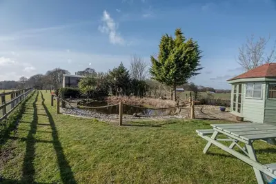 a yard with a picnic table and a fence at Lily Pad, Friston in Saxmundham