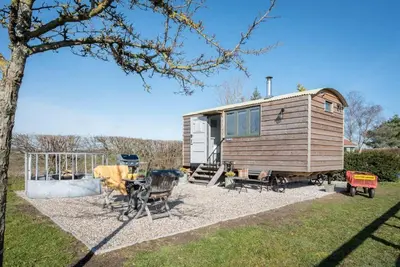 a tiny house sitting on gravel in a yard at Lily Pad, Friston in Saxmundham