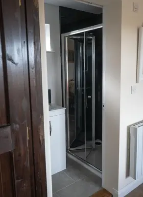 a walk in shower in a bathroom with a glass door at ROSE CHALET in Framlingham