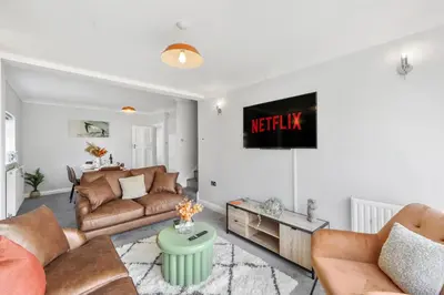 a living room with a couch and a table at Grab a Deal Today! Massive Home For Contractors & Parking for 4 in Chelmsford