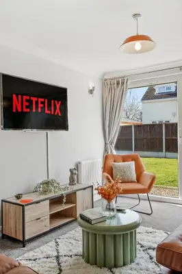 a living room with a netflix sign on the wall at Grab a Deal Today! Massive Home For Contractors & Parking for 4 in Chelmsford