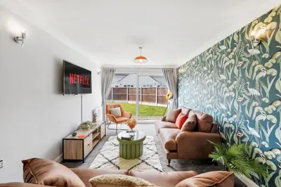 a living room with two couches and a tv at Grab a Deal Today! Massive Home For Contractors & Parking for 4 in Chelmsford