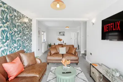 a living room with couches and a tv at Grab a Deal Today! Massive Home For Contractors & Parking for 4 in Chelmsford