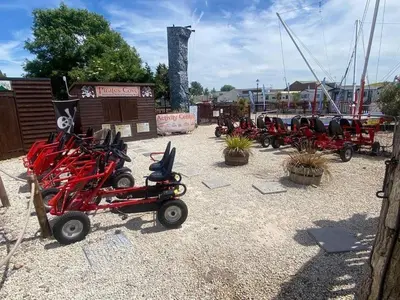 a row of red scooters parked in a parking lot at Arizona - Pura Vida Holidays Caravan in Clacton-on-Sea