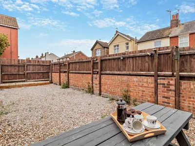 a wooden table with a tray of food on it at Harbour Walk in Brightlingsea