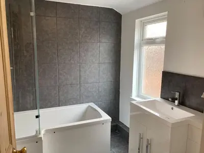 a bathroom with a white tub and a sink at Harbour Walk in Brightlingsea