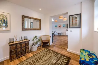 a living room with a dresser and a mirror at Springfield, Westleton in Westleton