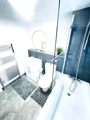 a bathroom with a toilet and a shower and a sink at 2 Bedroom Modern House in Cambridge city centre in Chesterton
