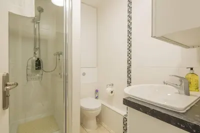 a bathroom with a sink and a toilet and a shower at Addenbrookes Flat 2 mins walk free Private Parking in Cambridge