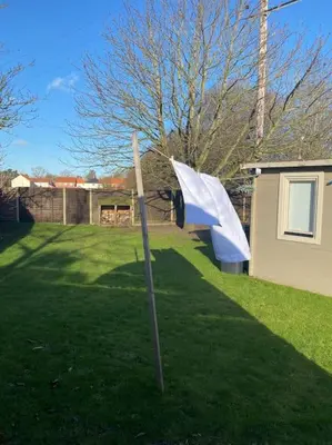 a white umbrella in the grass in a yard at The Chestnuts Pod with private garden. in Eccles