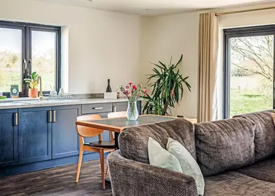a living room with a couch and a table at Old Buckenham Country Park in Old Buckenham