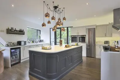 a large kitchen with a large island in the middle at 6 Bed in Lavenham oc-stofa in Lavenham