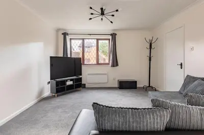 a living room with a couch and a flat screen tv at House on cul de sac in Lakenheath
