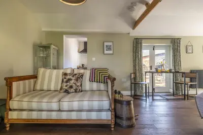 a living room with a couch and a table at The Firs in Cratfield