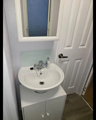a bathroom with a white sink and a mirror at Vacation Escape - Valley Farm -Clacton-on-sea - Holiday Park in Clacton-on-Sea
